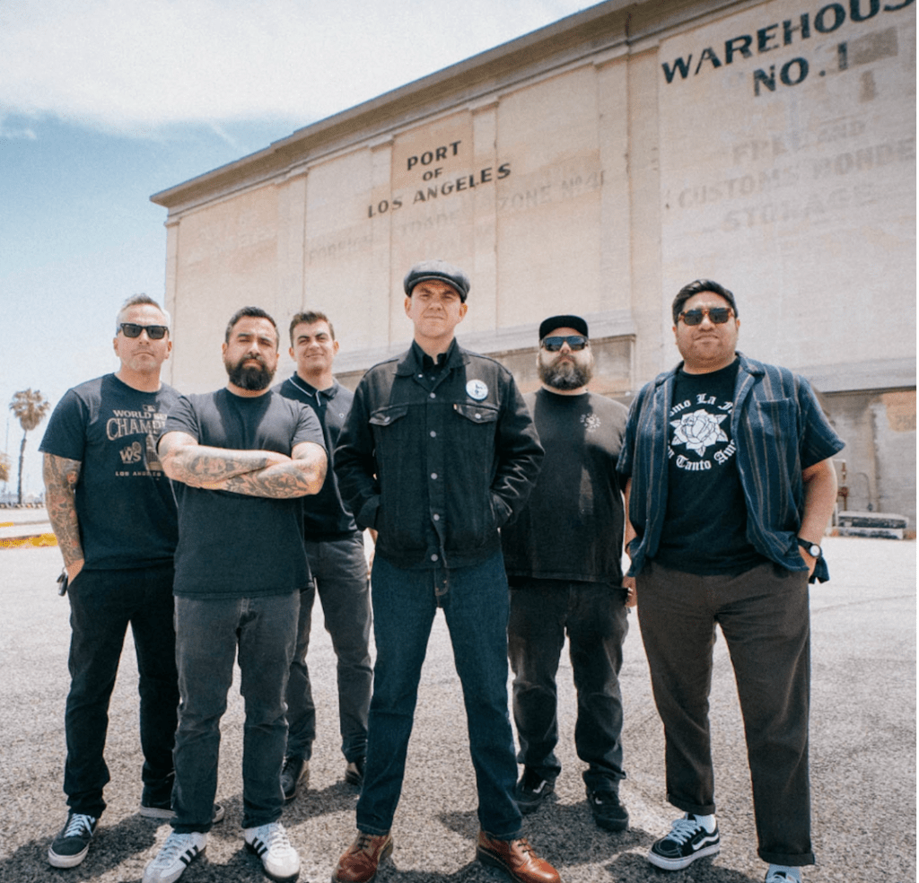 Hoist the Colors band members in front of a white warehouse