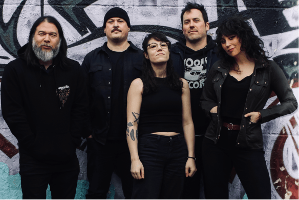 2 women and 3 men, dressed in black, looking at the camera.  In general they look either happy or defiant. 