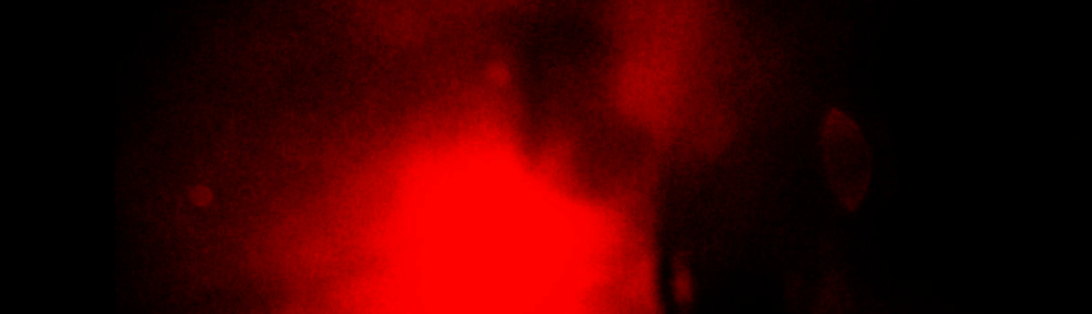 A very blurred image of a human figure standing in front of a bright light