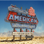 A large, vintage looking road sign that is lettered with the band name and album title. The image is in a desert setting with mountains in the background.